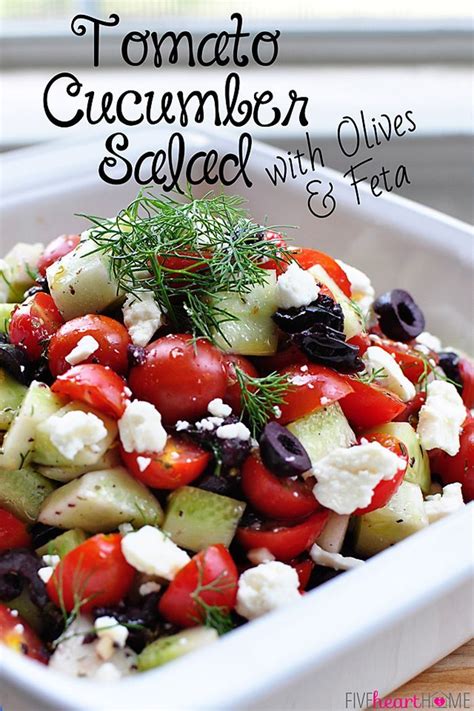 Tomato Cucumber Salad With Olives And Feta In A White Serving Dish