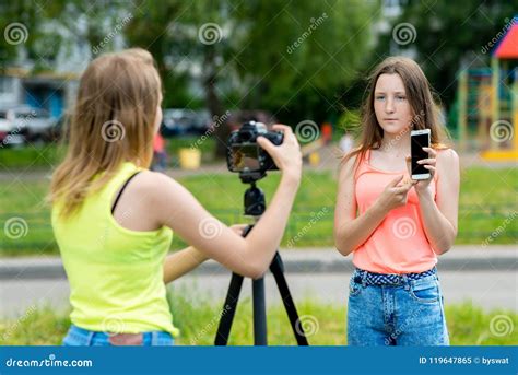 Two Girl Friends Summer Nature Writes Video To Camera In His Hands Holds Smartphone The