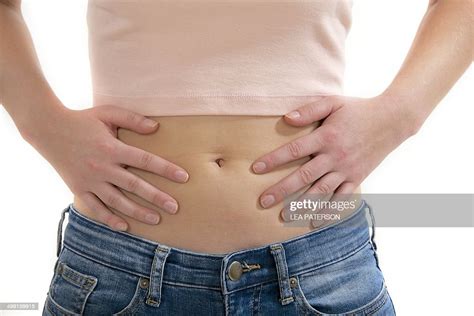 Teenage Girl Touching Stomach Photo Getty Images