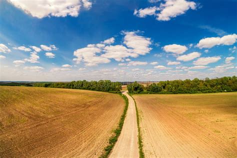 Aerial View Of Dirt Road Through The Plowed Field In Spring Stock Image