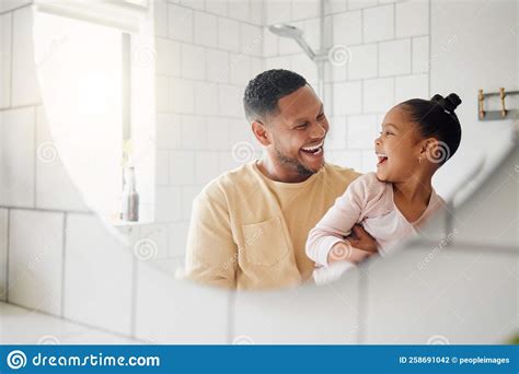 Happy Mixed Race Father And Daughter Washing Their Hands Together In A
