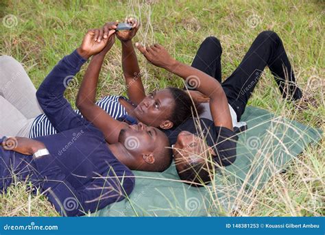 Best Friends Man And Woman Lying On The Grass And Laughing Stock Image