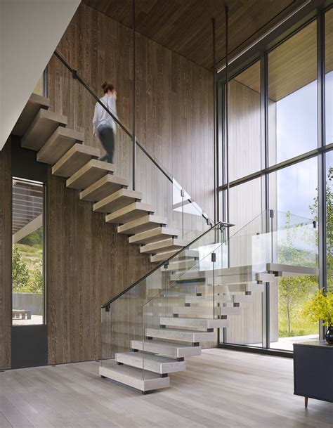 Two Story Window Frames An Impressive Mountain View Entry With Suspended Stair By Robbins