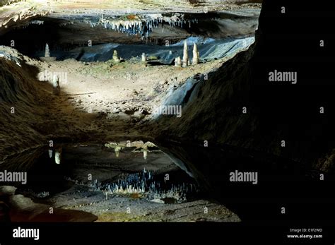Stalactite And Stalagmite Limestone Rock Formations Reflected In A