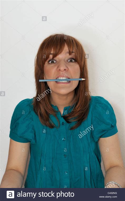 Young Woman Biting Pencil Stock Photo Alamy