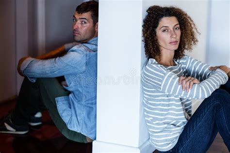 Couple Sitting Opposite Sides Wall Stock Photos Free And Royalty Free