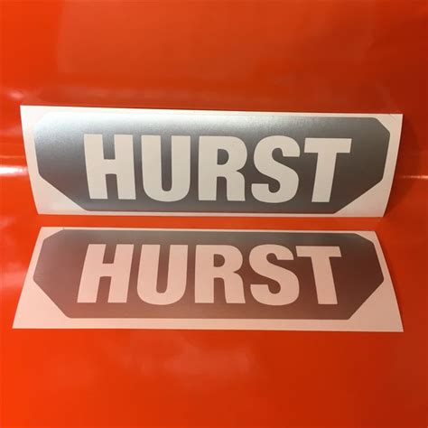 Two Stickers On The Side Of A Red Car That Says Hurst And Is White