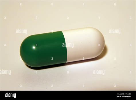 Green and white medical pill. Antibiotic capsule Stock Photo - Alamy