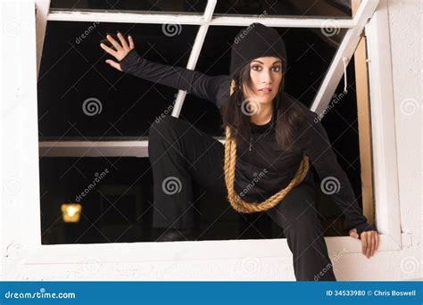 Female Intruder Sneaks In Through Open Window Thief Prowler Stock Photo