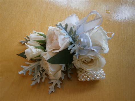 Pearl Wristlet Of Spray Roses Accented With Dusty Miller Creation By