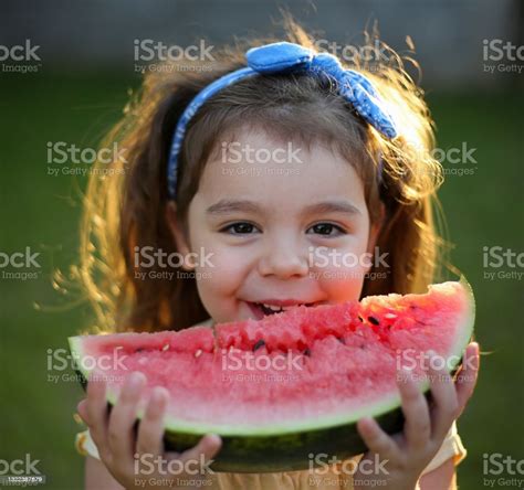 Cute Little Child Girl Eating Watermelon Fresh Fruit In The Garden