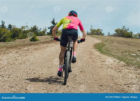 Rear View Athlete Cyclist Riding Mountain Bike Uphill Stock Photo