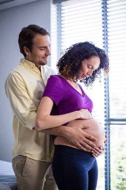 Premium Photo Man Touching Pregnant Womans Belly In Ward