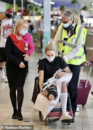 And there's still a long way to go before she's fully recovered. Allison Langdon is pushed through Gold Coast Airport in a wheelchair after injuring herself on ...