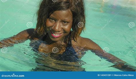 happy and beautiful black afro american woman in bikini having fun at tropical beach resort