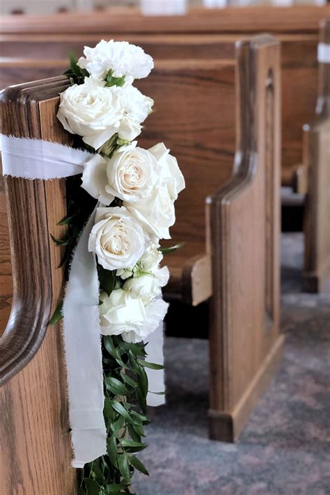White Rose Flower Swag And Greenery Tied On Church Pew With White