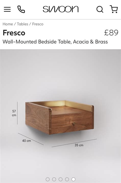 A Wooden Box Sitting On Top Of A Table Next To A Wall Mounted Bed Frame