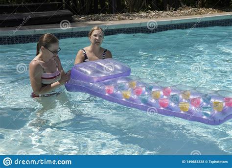 Two Women Work On A Flotation Device In A Pooll Editorial Stock Photo Image Of Work Pool