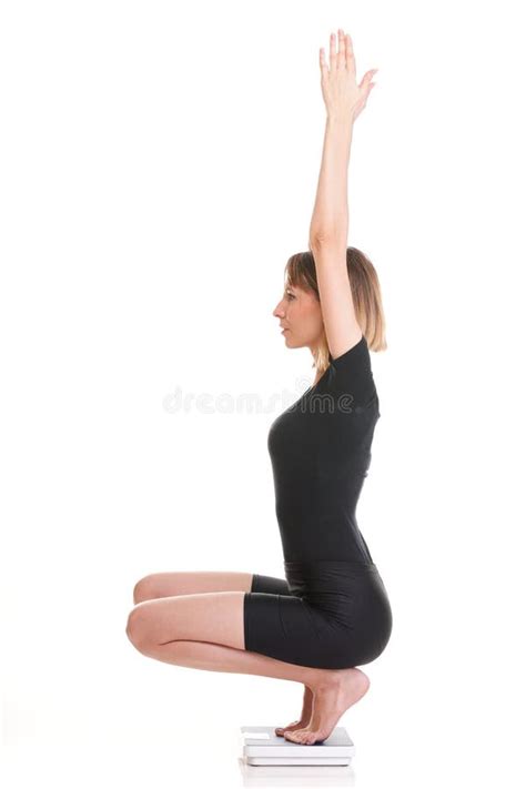 Portrait Of A Happy Woman Squatting On Scales Isolated Stock Image