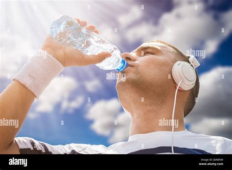 Portrait Of Thirsty Sportsman Drinking Water From The Plastic Bottle