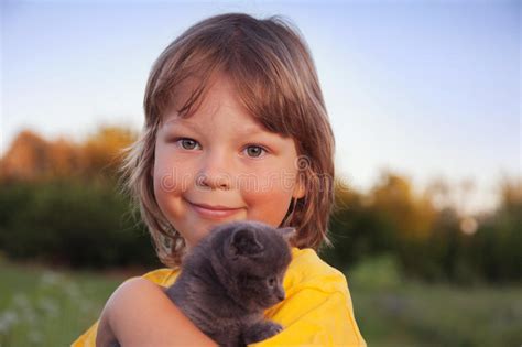 Kitten On Arm Of The Boy Outdoors Child Huge His Love Pet Stock Image