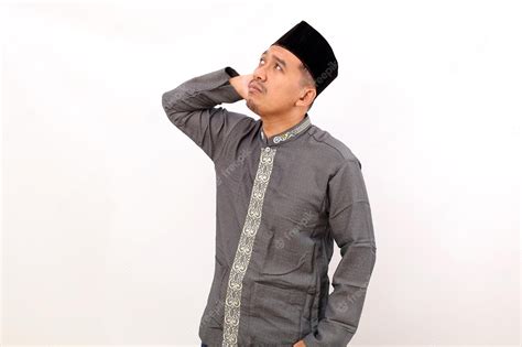 Premium Photo Thoughtful Asian Muslim Man Standing While Thinking For