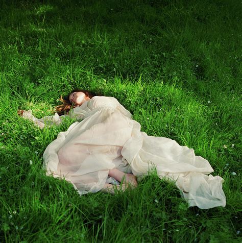 Woman Lying Down On Grass By Lisa Kimmell