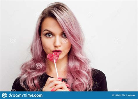 Portrait Of A Young Woman With Pink Hair And Pink Candy Concept