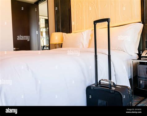 Luggage Baggage Suitcase Beside The King Size Freshly Made Bed In A