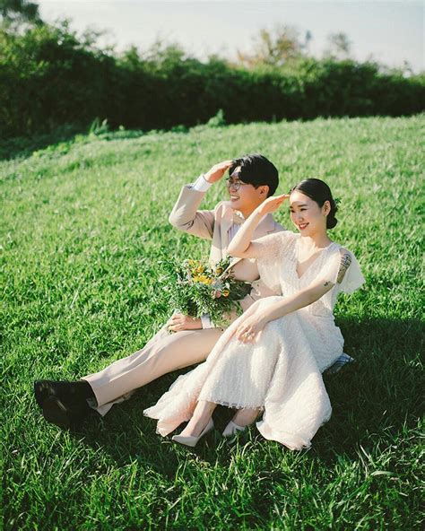 Two People Sitting In The Grass Together