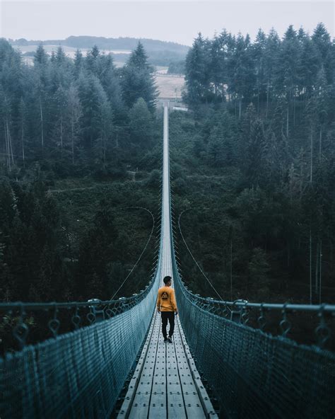 Man Walking On Suspension Bridge · Free Stock Photo