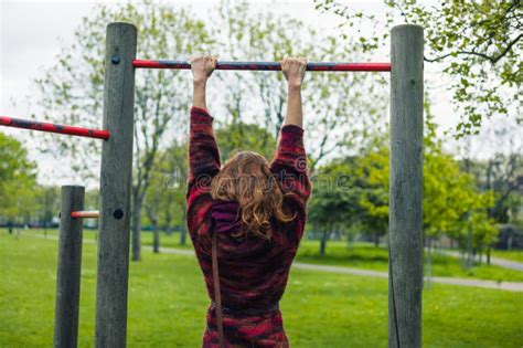 Woman Doing Pull Ups In A Park Stock Photo Image Of Healthy Body