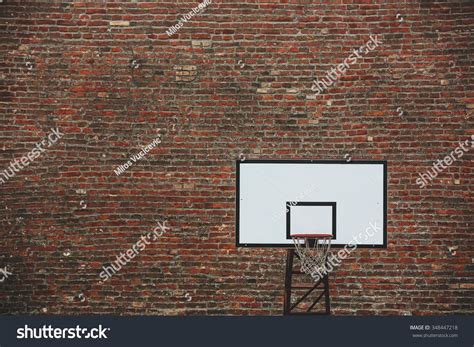 Basketball Court Outdoor In Front Of A Old Brick Wall Toned Photo