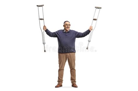 Happy Mature Man Holding Crutches Up After Recovery Stock Photo Image