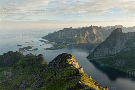 Female Hiker On Mountain Ridge With Reine And Reinefjord In The