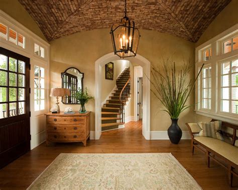 Gorgeous foyer designed with a fabulous sunburst mirror mounted above the wooden console table. Front Door Entryway Home Design Ideas, Pictures, Remodel ...