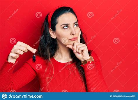 Young Hispanic Woman Holding Cockroach Serious Face Thinking About