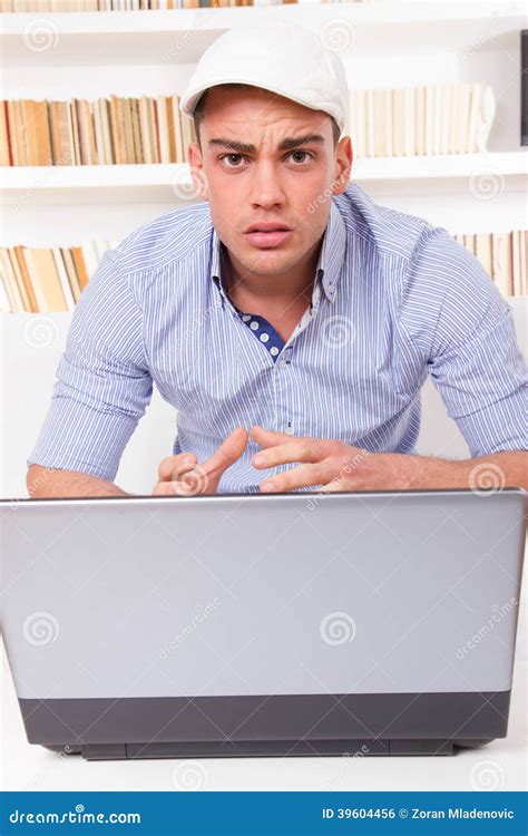 Worried Young Man Having Problems With Laptop Computer Stock Photo
