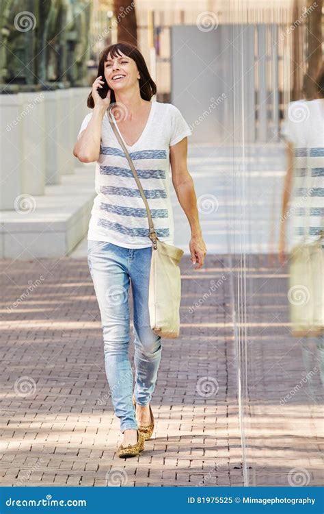 Cheerful Woman Walking On Sidewalk With Smart Phone Stock Image Image