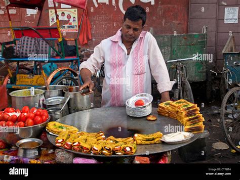 Man Cooking Food On Huge Frying Pan In The Street In Old Delhi India