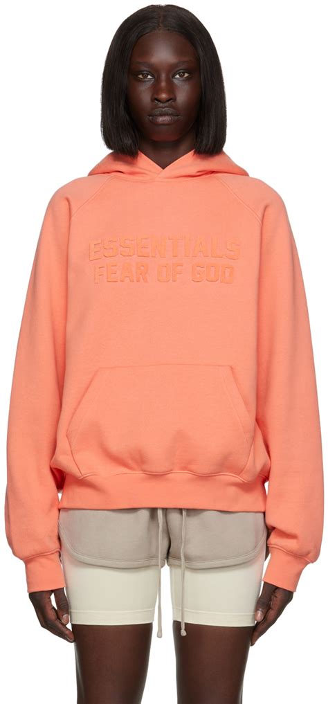 fear of god essentials pink raglan hoodie ssense