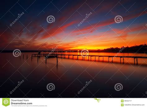 Wooden Dock And Fishing Boat At The Lake Sunset Shot Stock Image