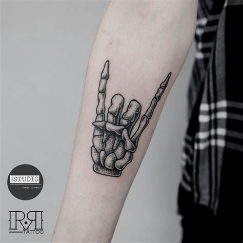Skeleton Hand Holding Tattoo