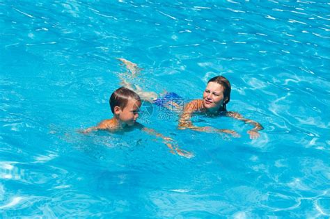 母亲教她儿子在夏季户外游泳池高清图片下载 正版图片306959721 摄图网