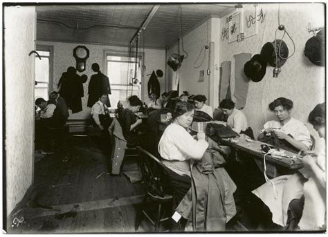 An Old Black And White Photo Of People Sewing