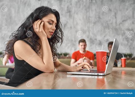 Female Freelancer Sitting In Cafe And Working With Computer Stock Photo