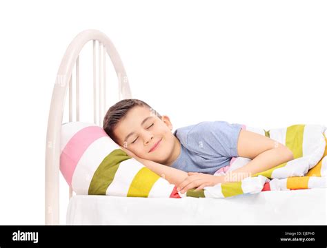 Cheerful Little Boy Sleeping In A Comfortable Bed And Dreaming Sweet