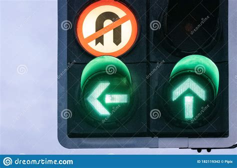 Uk Traffic Light Green Arrows Pointing Left And Ahead Stock Photo