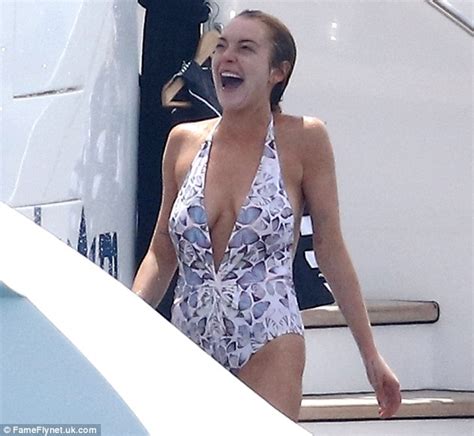 lindsay lohan gives egor tarabasov an eyeful in plunging swimsuit on cannes yacht daily mail