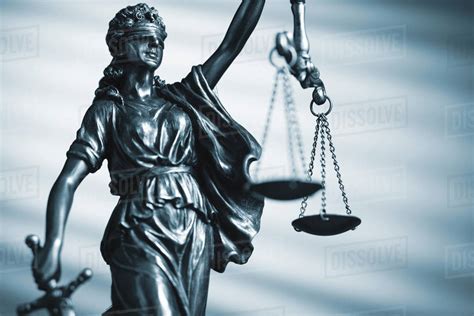 Blindfolded Figure Of Justice Holding Scales And A Sword Conceptual Of